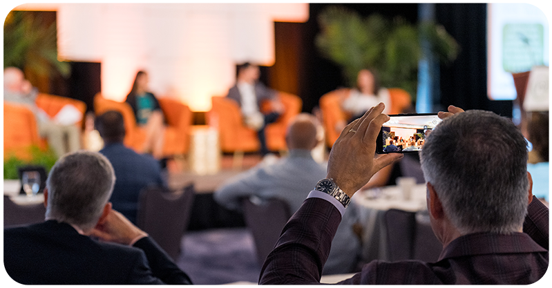 Attendee taking photo at the FMI FreshForward 2024 event.